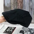 Close-up of black retro newsboy cap made of textured cotton on a vintage wooden background - Adjustable / Black