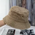 Close-up of khaki cotton bucket hat featuring metal eyelets and fine stitching details - M / Khaki