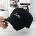 Detailed embroidery of white HELLO WEEKEND letters on a black cotton baseball cap - Adjustable / Black