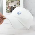 Close-up of white canvas baseball cap featuring blue Teddy bear embroidery detail - Adjustable / White
