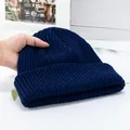 Close-up of dark blue ribbed knit beanie with thick texture and classic folded cuff - High Elasticity / Navy Blue