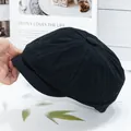 Detail view of black canvas octagonal newsboy cap with classic 8-panel stitched design - Black