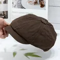 Detail shot of a dark brown newsboy cap with premium stitching and button top - Coffee