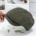 Detailed side view of military green cotton newsboy cap showing durable double-stitch seams - Green