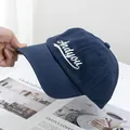 Close-up of navy blue cotton baseball cap with white Andyou embroidery on a clean background - Adjustable / Navy Blue