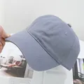 Detailed close-up of grey washed cotton baseball cap with reinforced stitching on the brim - Adjustable / Light Gray