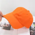 Detail view of bright orange cotton baseball cap with reinforced stitching and eyelets - Adjustable / Orange