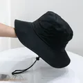 Detail of a black quick-dry outdoor bucket hat with wide brim and adjustable wind rope - Kids (50-54cm) / Black