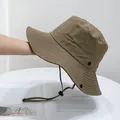 Close-up of khaki outdoor bucket hat featuring adjustable windproof cord and side snaps - Army Green