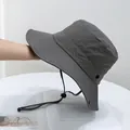 Close-up of wide brim sun hat featuring windproof rope and metallic breathable eyelets - Kids (50-54cm) / Gray