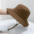 Detail of a brown outdoor sun hat with adjustable drawstring and parallel stitching - Kids (50-54cm) / Camel