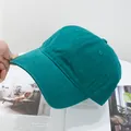 Macro view of dark green cotton twill baseball cap with curved brim and air vents - Adjustable / Forest Green