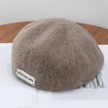 Detail view of coffee brown wool newsboy cap showing fuzzy texture and decorative label - Adjustable / Mocha