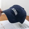 Macro detail of navy corduroy baseball cap with white Colorado embroidery and fine stitching - Navy Blue