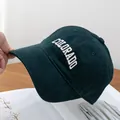 Close-up of white Colorado 3D embroidery on deep green textured baseball cap - Dark Green