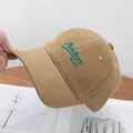 Close-up of khaki cotton baseball cap featuring blue Missebean 1987 embroidery detail - Adjustable / Khaki
