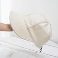 Detail of warm off-white plush cap featuring an adjustable drawstring and thick lining - Adjustable / Beige