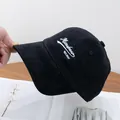 Detail shot of black brushed cotton baseball cap with white Mioobean letter embroidery - Adjustable / Black