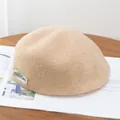 Elegant beige wool newsboy cap for women with vintage metal logo detail and warm texture - Adjustable / Khaki