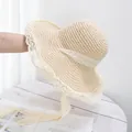 Detailed close-up of cream straw hat featuring hollow weave and elegant lace brim - Adjustable / Beige