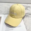 Pale yellow baseball cap with Colorado embroidery on an open book, soft cotton texture - Yellow