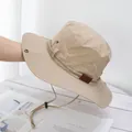 Detail of beige sun hat with mountain embroidery, metal eyelets, and adjustable chin strap - M / Khaki