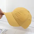 Detail of yellow baseball cap showing soft quick-dry fabric and flexible curved brim - Adjustable / Dark Yellow
