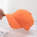 Detailed side view of a thin orange baseball cap in lightweight quick-dry fabric - Adjustable / Orange