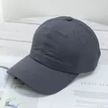 Detail view of a dark grey lightweight baseball cap on a stylish magazine background - Adjustable / Dark Gray