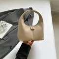 Minimalist beige leather hobo handbag featuring a sleek half-moon arc design for women - Khaki