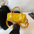 Vibrant yellow cylindrical sports handbag with adjustable shoulder strap and soft nylon texture - Small / Yellow