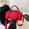 Red nylon cylindrical tote bag with adjustable shoulder straps for fitness and travel - Small / Red