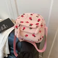 Pink corduroy crossbody bag with cute strawberry print and adjustable shoulder strap - Pink