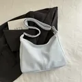 Light blue-grey faux leather hobo bag with adjustable strap and silver metal hardware - No Pendant / Blue