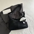 Minimalist black matte shoulder bag with white lettering and cloud plush charm detail - With Pendant / Black