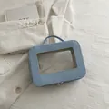 Neceser azul claro con ventana transparente y asa superior para viaje y maquillaje - Azul