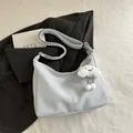 Light blue faux leather crossbody tote bag featuring a plush white cloud charm - With Pendant / Blue