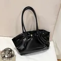 Minimalistische schwarze Lackleder-Achseltasche mit glänzendem Finish und Goldverschluss - Schwarz