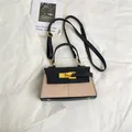 Minimalist trapezoid handbag in black leather and khaki fabric with gold hardware - Black