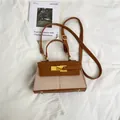 Elegant trapezoid handbag in brown leather and cream canvas with golden kelly lock - Brown