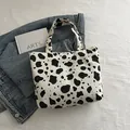 Minimalist black and white cow print corduroy tote bag with spacious shoulder strap design - White