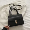 Minimalistische schwarze Handtasche mit Litschi-Textur und goldenem Verschluss - Schwarz