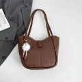 Dark brown faux leather tote bag with vertical stitching and a fuzzy white charm - With Pendant / Brown