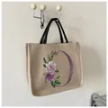 Borsa tote in juta retrò con stampa floreale O e manici intrecciati neri in beige - Stile O (Stampa Floreale Lettera O)