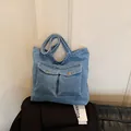 Washed blue denim tote bag with two front pockets and wide straps for commuting - No Pendant / Light Blue