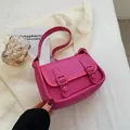 Chic magenta leather crossbody bag with decorative straps and light pink contrast piping - Rose Pink