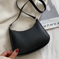 Fashionable black crescent shoulder bag in lychee pattern leather with gold hardware - Black