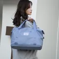 Light blue travel bag with luggage sleeve and separate bottom shoe compartment - Haze Blue