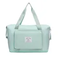 Mint green waterproof nylon travel bag with front pocket and expandable bottom - Green