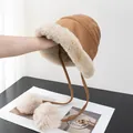 Detail of camel plush bucket hat featuring soft faux suede and fluffy white pom-pom ties - M (56-58cm) / Khaki